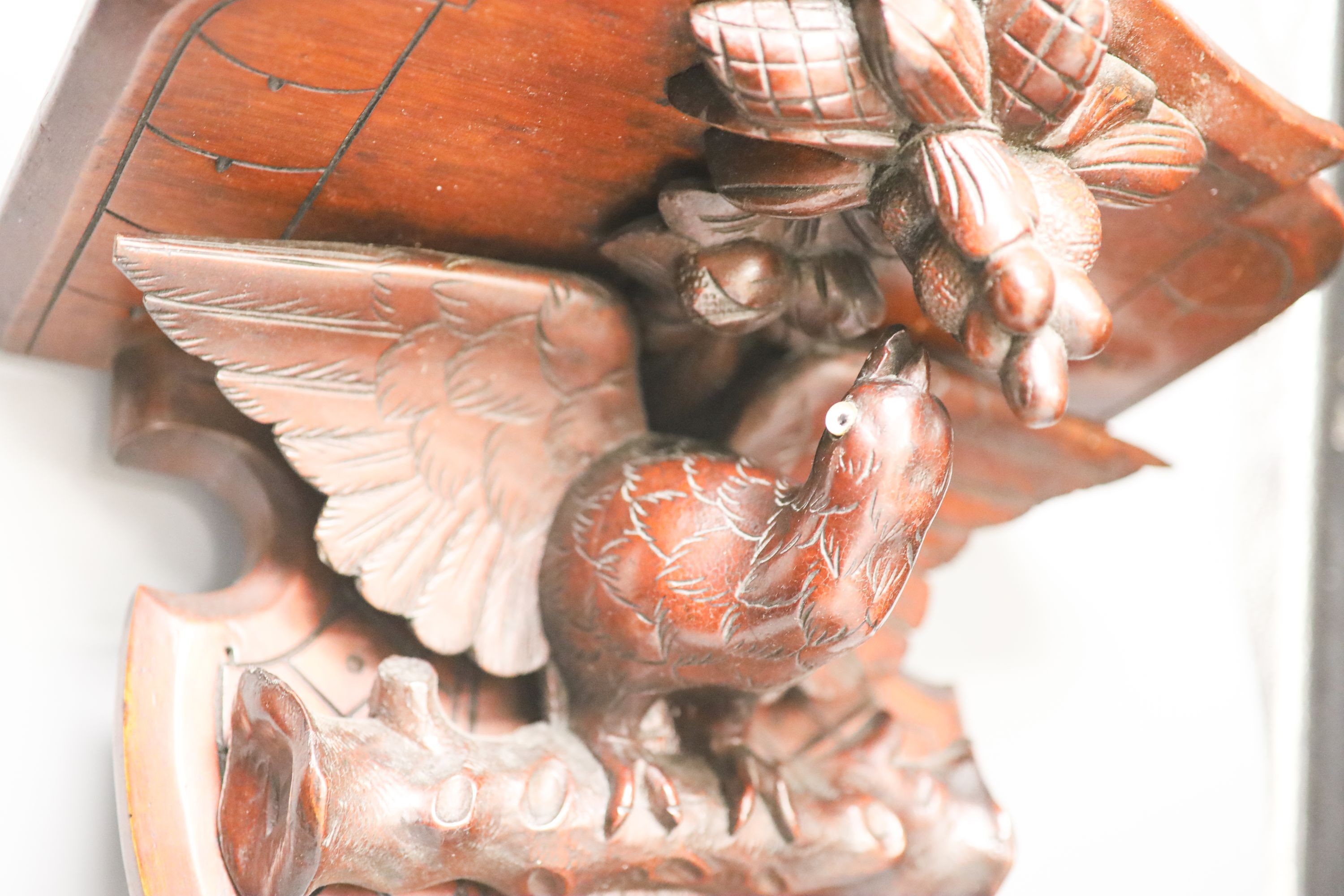 A late 19th century carved mahogany ‘eagle’ wall bracket with glass eyes 51cm